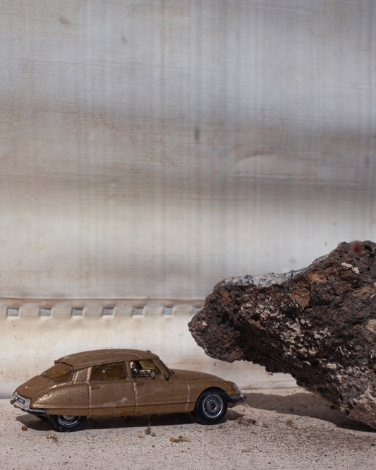 between a rock & a car place by Madisyn Simington